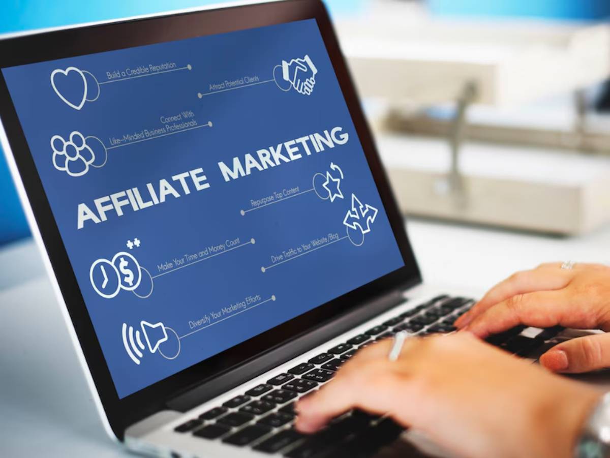 Close-up of hands typing on a laptop, displaying an Affiliate Marketing infographic with strategies for success.